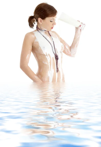 stock image Topless girl with glass of yogurt in water