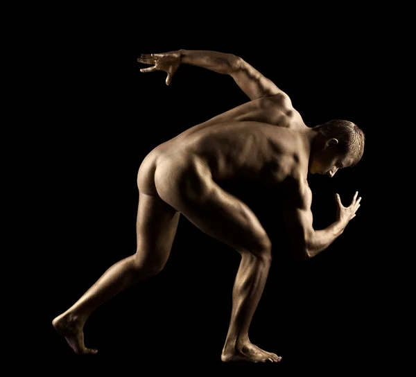 stock image Athletic man posing nude in dark