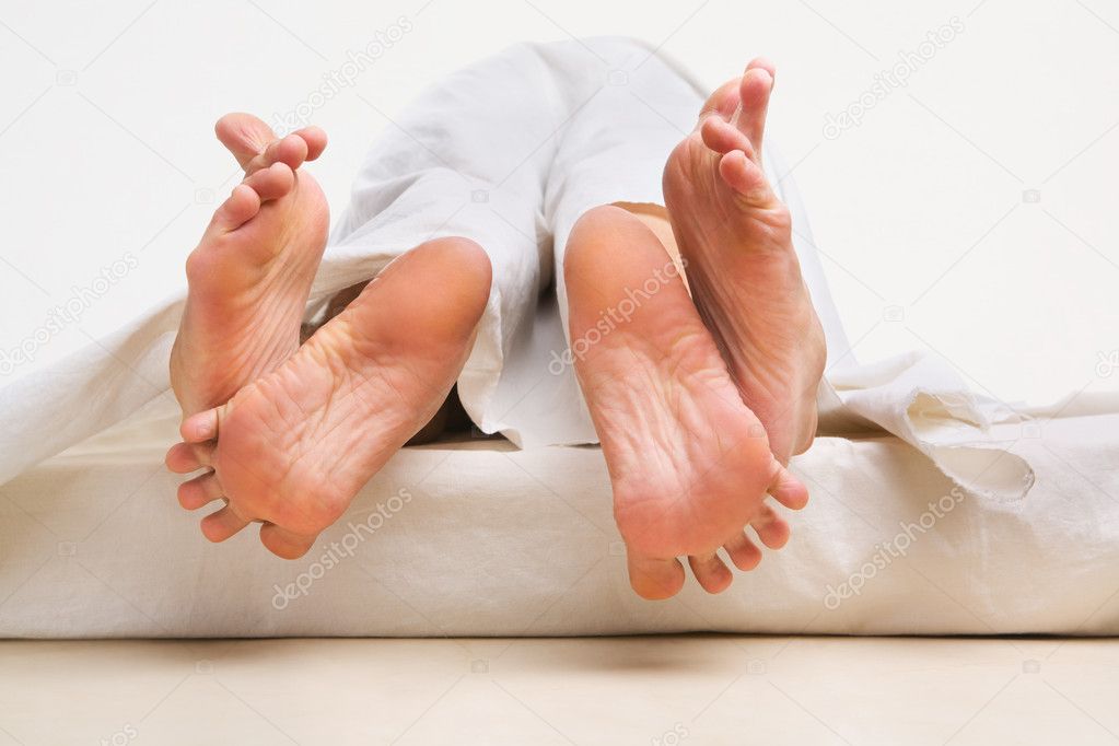 Feet of couple making love