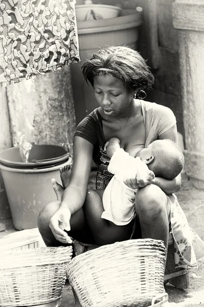 stock image Ghanaian woman feeds her baby with a breast