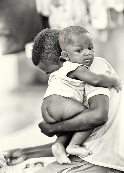 stock image A Ghanaian man takes care of his son